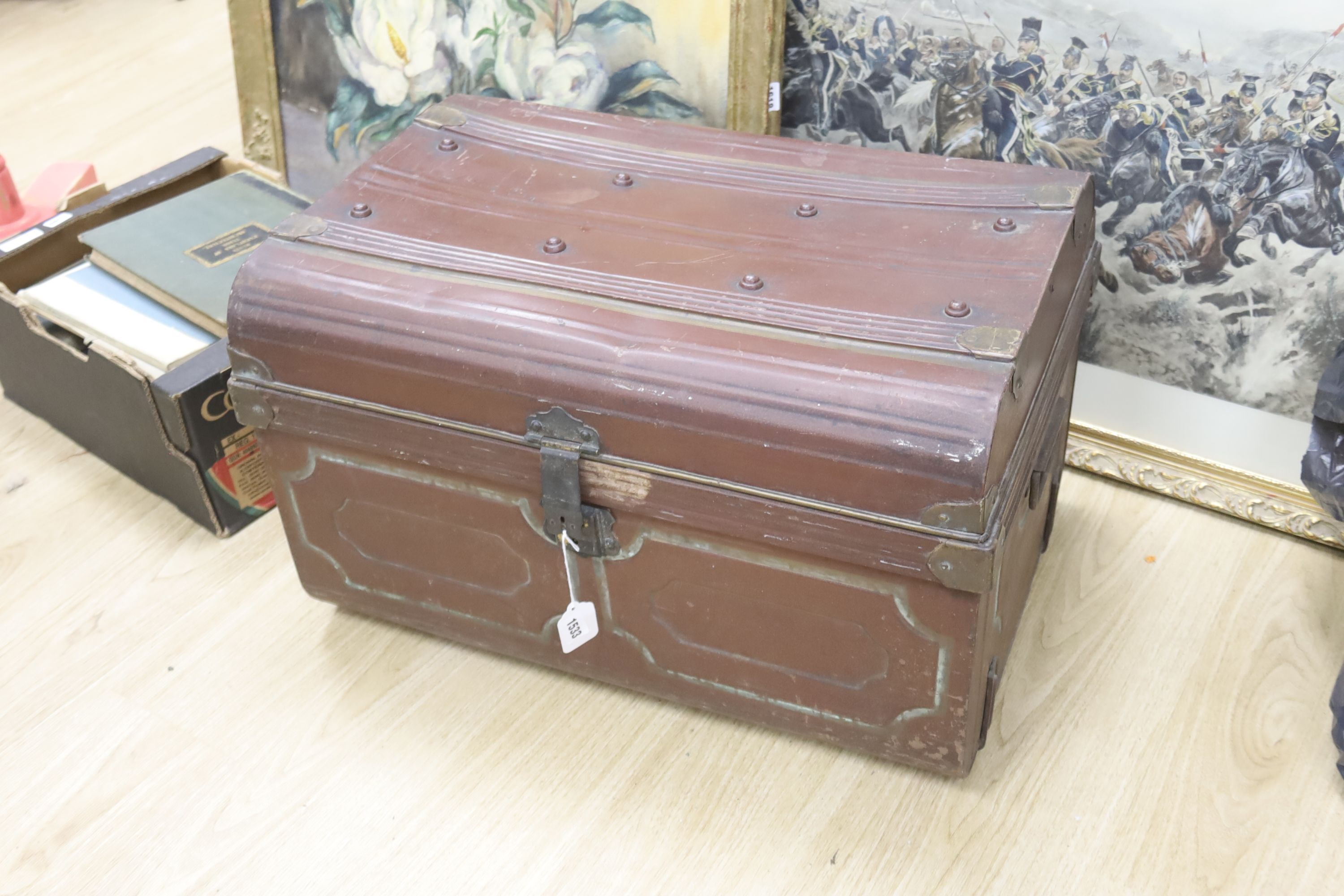 A tin trunk containing a scalloped linen sheet with embroidered monogram linen crochet tablecloths, chemical lace cloth etc.